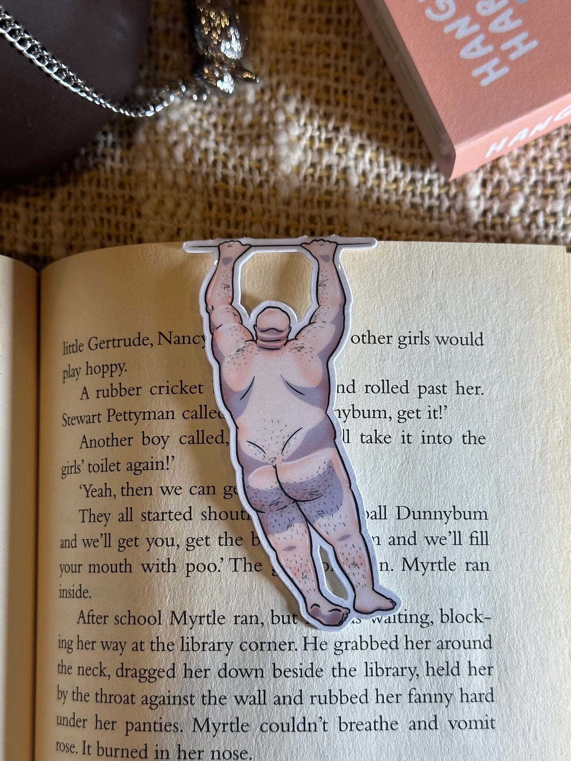 Naked man magnetic bookmark on page